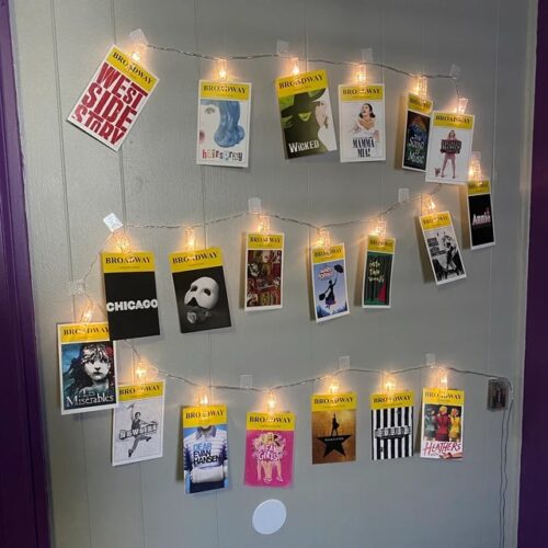 playbills with clip lights on the wall